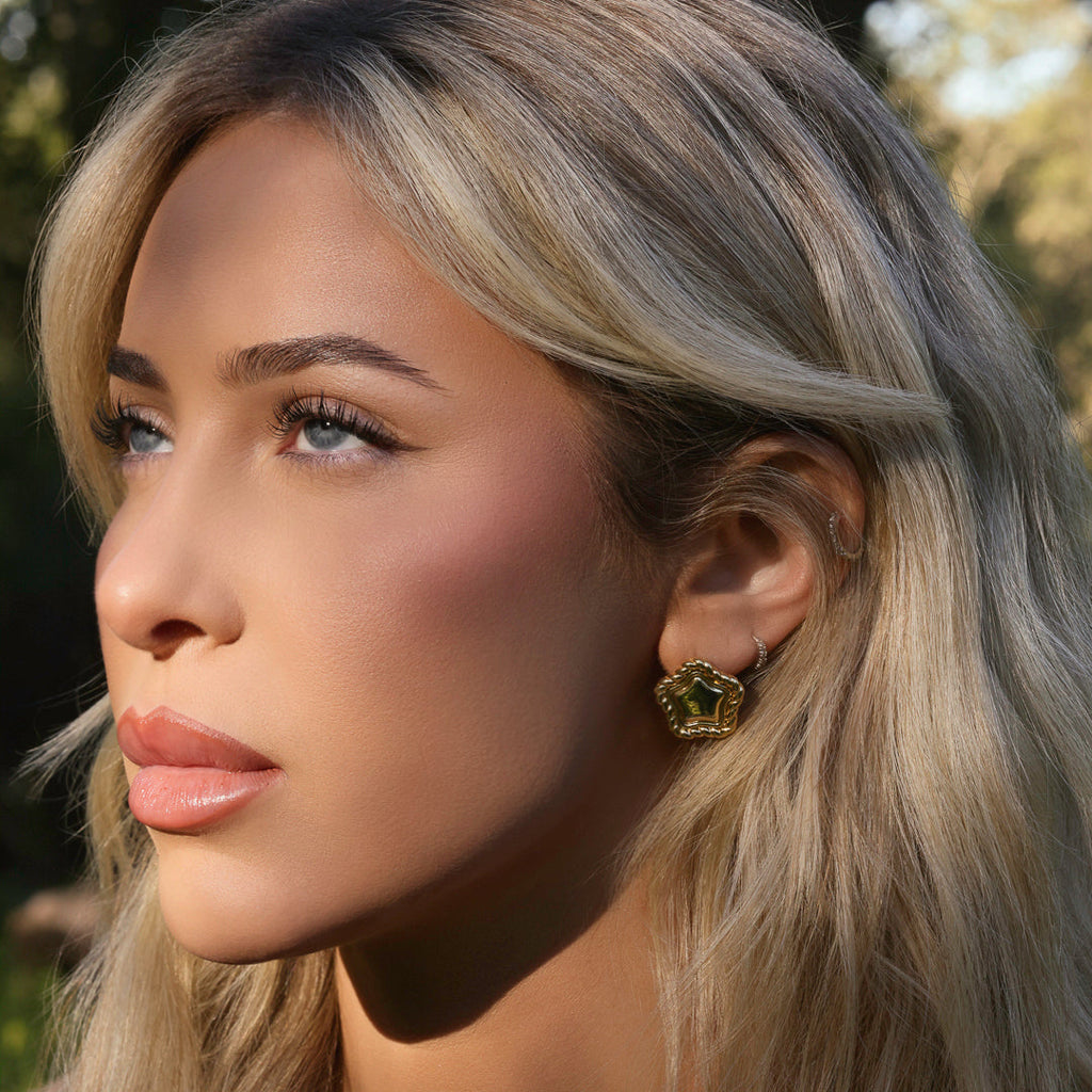 LA FORZA Daisy Earrings close-up on model showing textured border detail